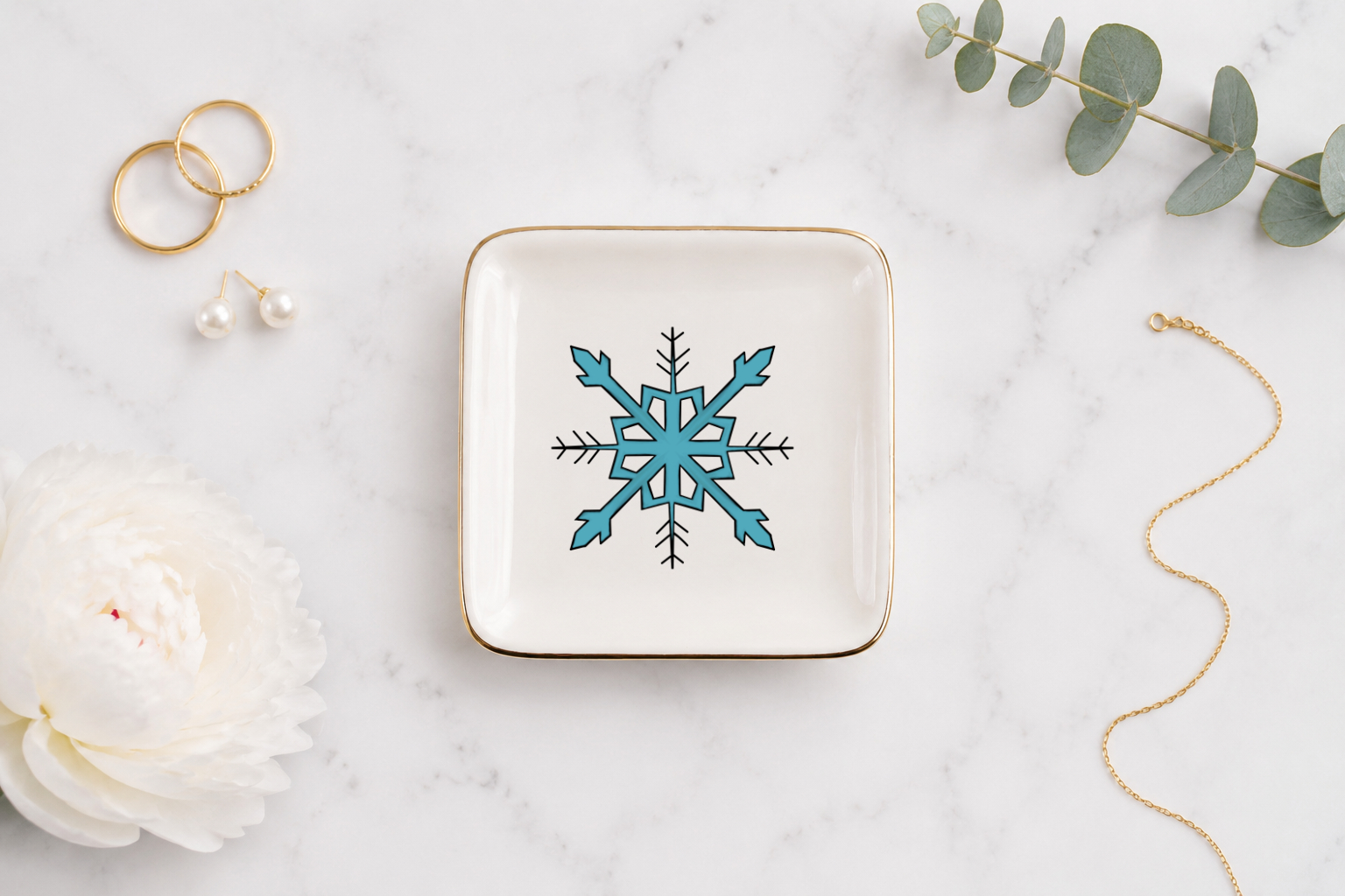 Snowflake ceramic trinket tray with a blue snowflake and gold rim
