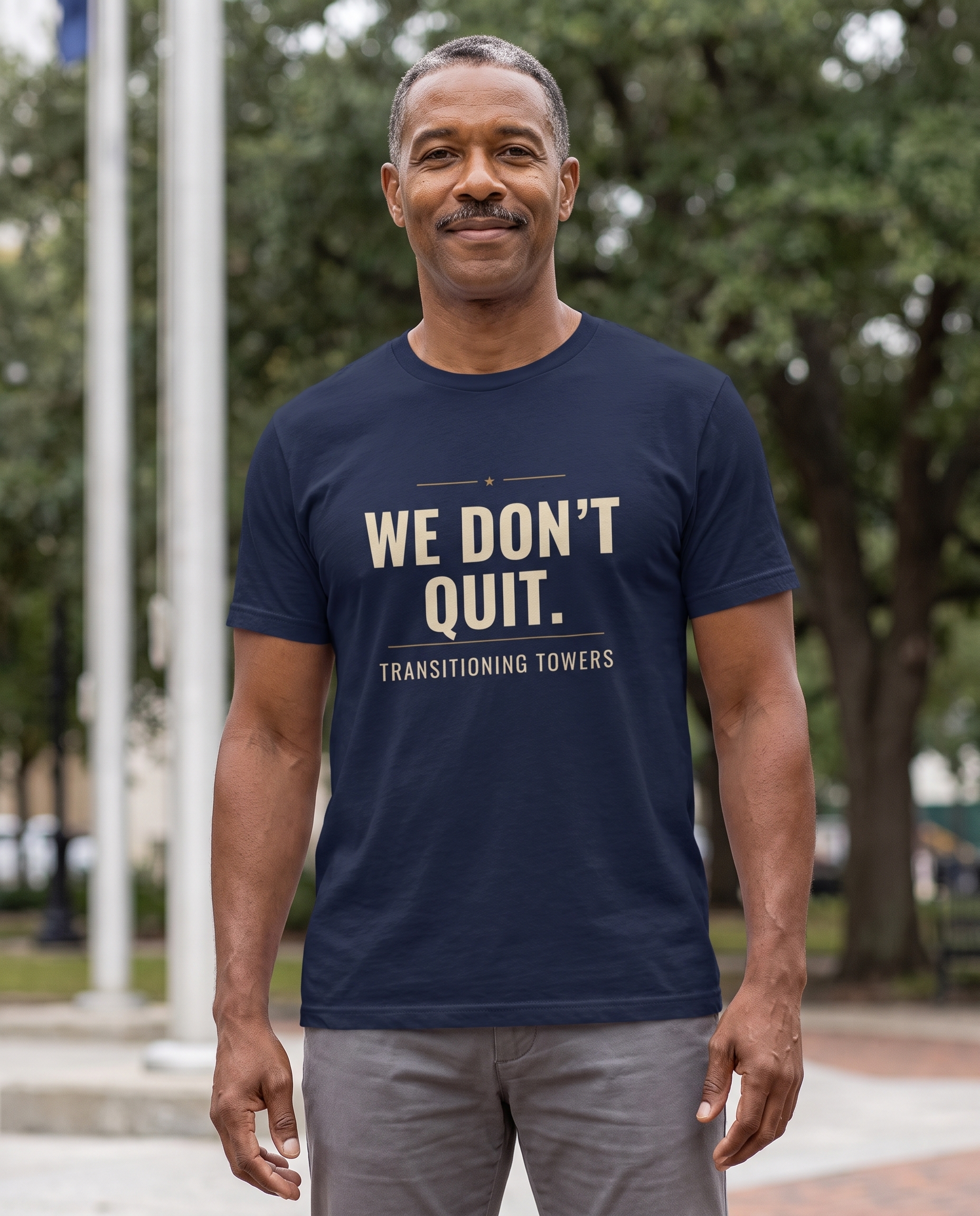 Man wearing the navy We Don't Quit tee